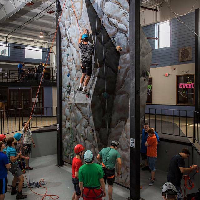 Teen boys climbing the Calo rockwall